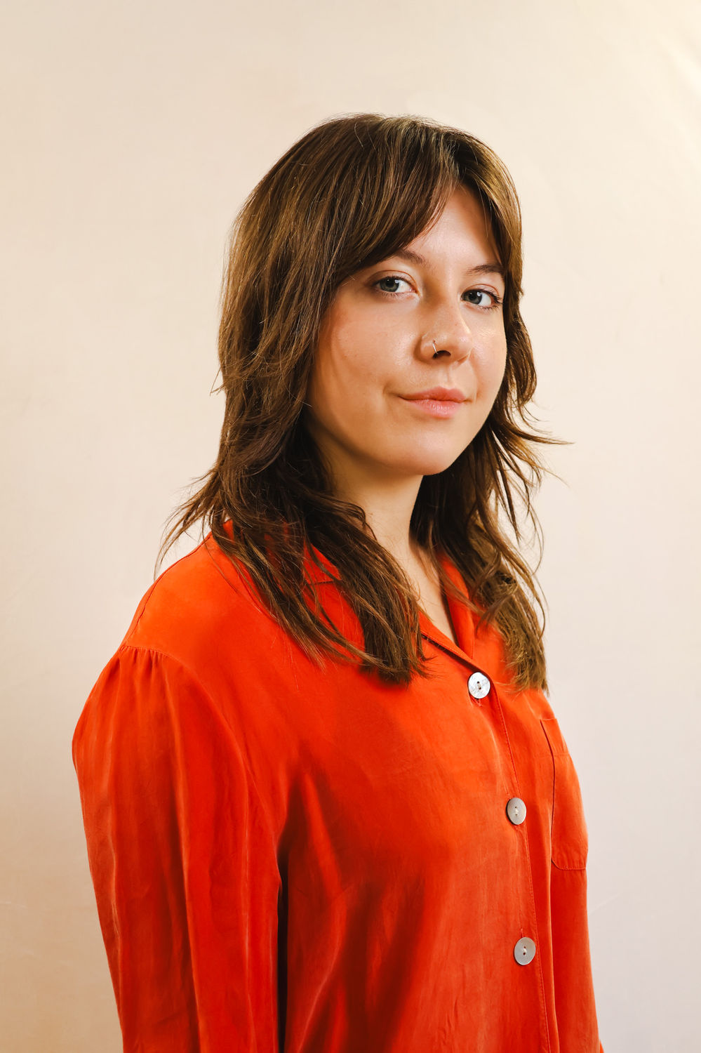 Personal portrait photographed against a neutral backdrop at a King's Cross London studio.