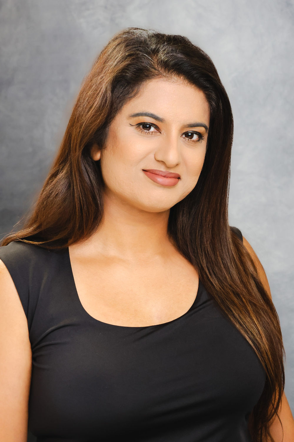 Confident business headshot photographed against a neutral backdrop in King's Cross, London.