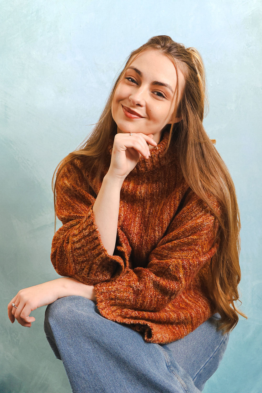 Relaxed personal portrait photographed against a soft coloured backdrop at the Ceeb Moz London studio.