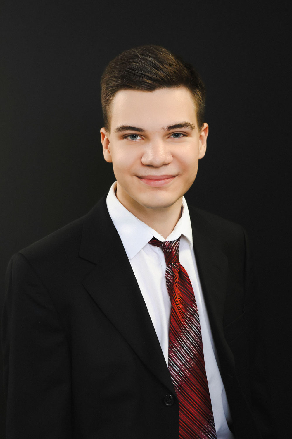 Formal business headshot of a man in a suit, photographed at the Ceeb Moz studio in King's Cross, London.