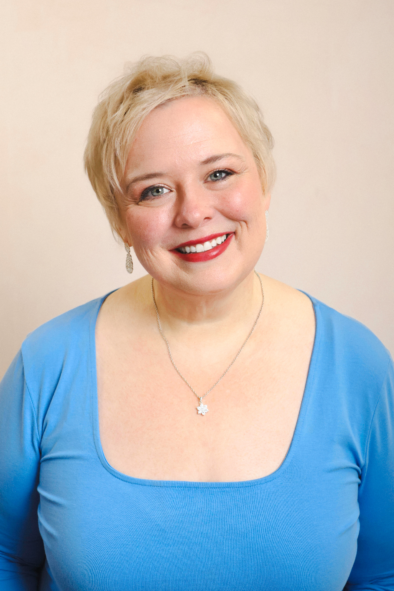 Friendly professional portrait with soft warm backdrop